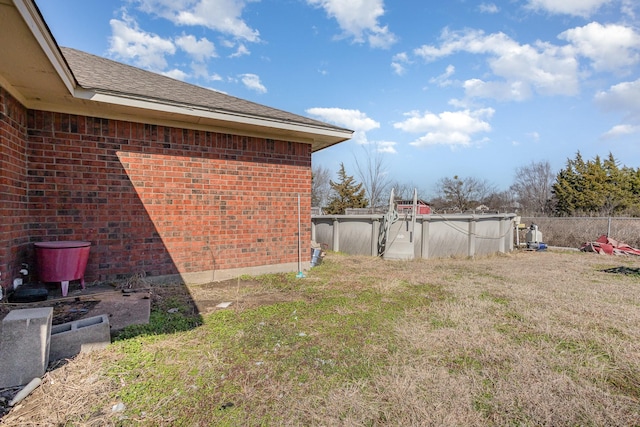 view of yard with a covered pool and fence