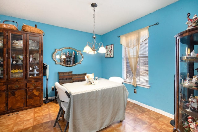 dining space with a chandelier and baseboards