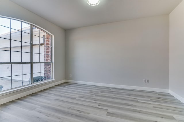 empty room with light hardwood / wood-style flooring