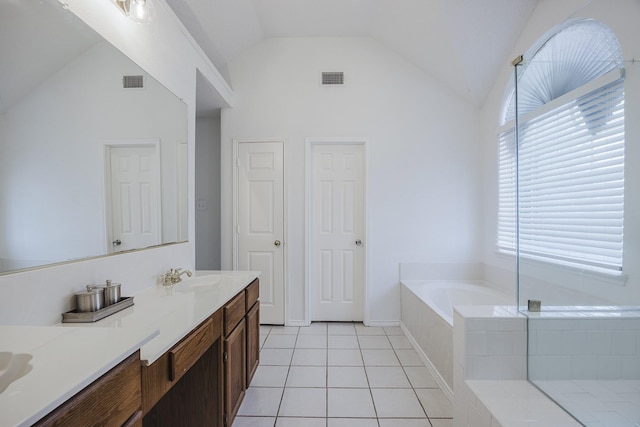 full bath with lofted ceiling, visible vents, a sink, a bath, and tile patterned floors