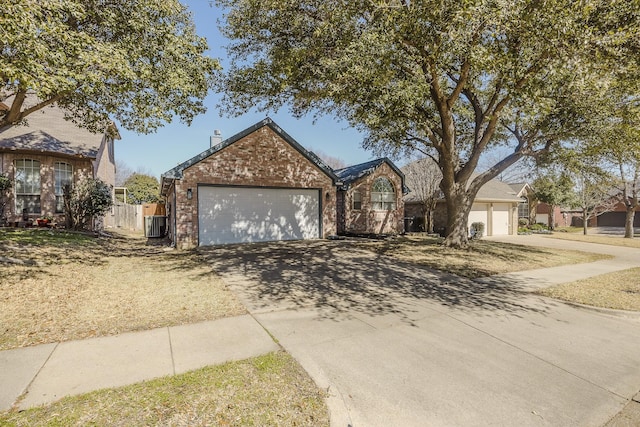 ranch-style home with concrete driveway, brick siding, and an attached garage