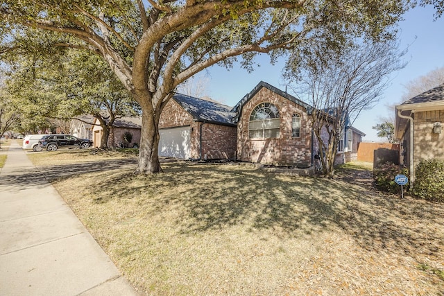 ranch-style house featuring brick siding and an attached garage