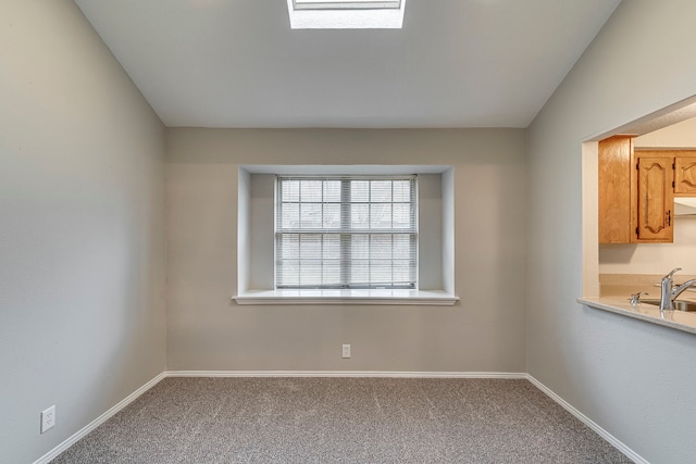 unfurnished room featuring sink and carpet floors