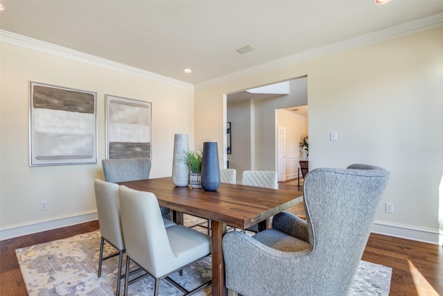 dining room featuring ornamental molding, recessed lighting, dark wood-style flooring, and baseboards