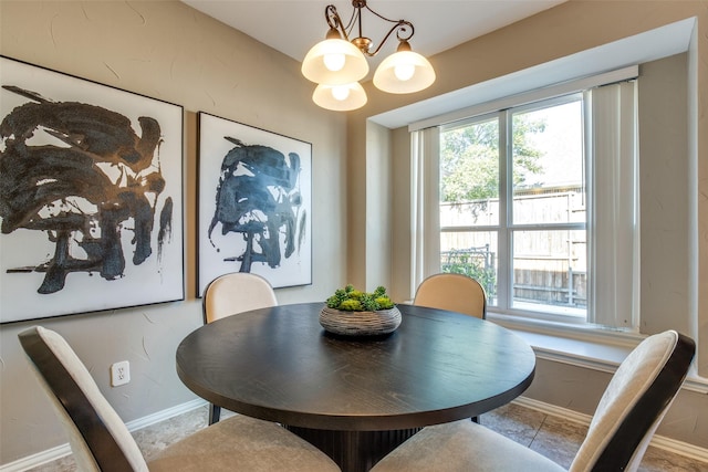 dining room featuring an inviting chandelier, baseboards, and a wealth of natural light