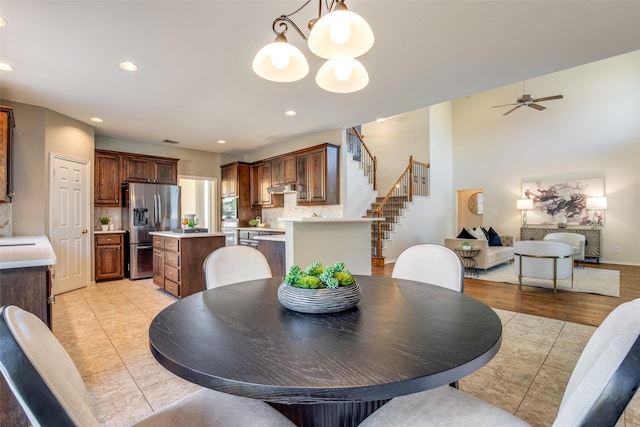 dining area featuring recessed lighting, stairway, and light tile patterned floors