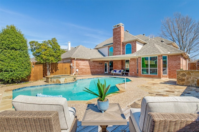 view of pool featuring an in ground hot tub, a patio, a fenced backyard, and a fenced in pool