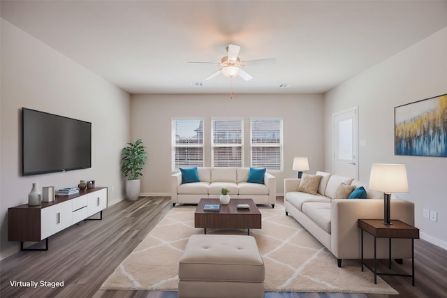 living room featuring ceiling fan, wood finished floors, visible vents, and baseboards