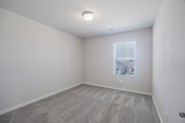 unfurnished room with visible vents, baseboards, and carpet