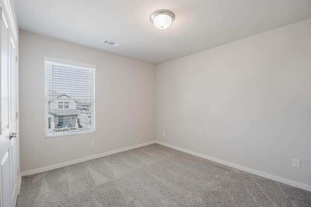 unfurnished room with visible vents, carpet flooring, and baseboards