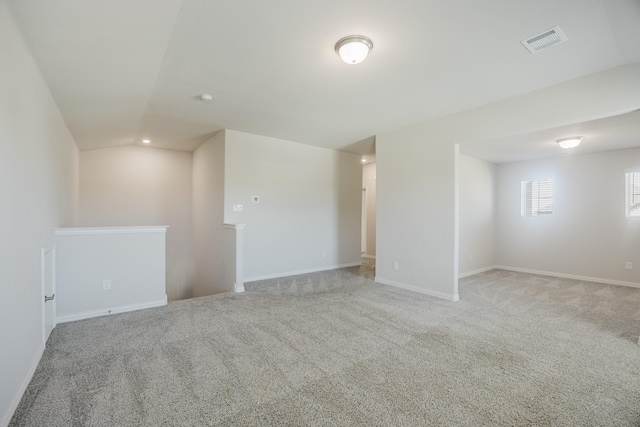 unfurnished room featuring baseboards, visible vents, and carpet floors