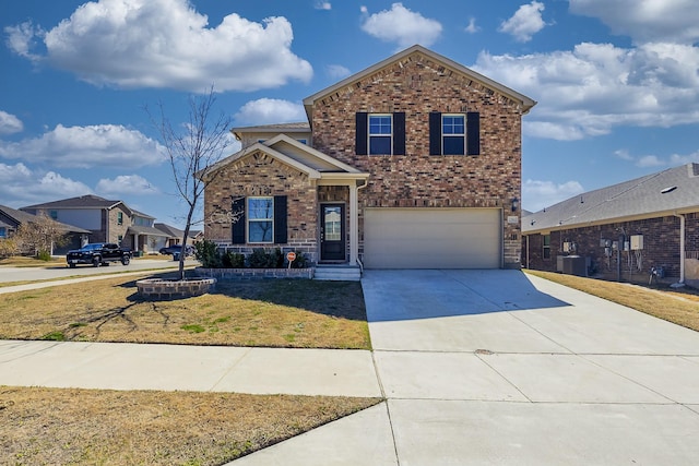 traditional-style home featuring brick siding, an attached garage, a front lawn, cooling unit, and driveway