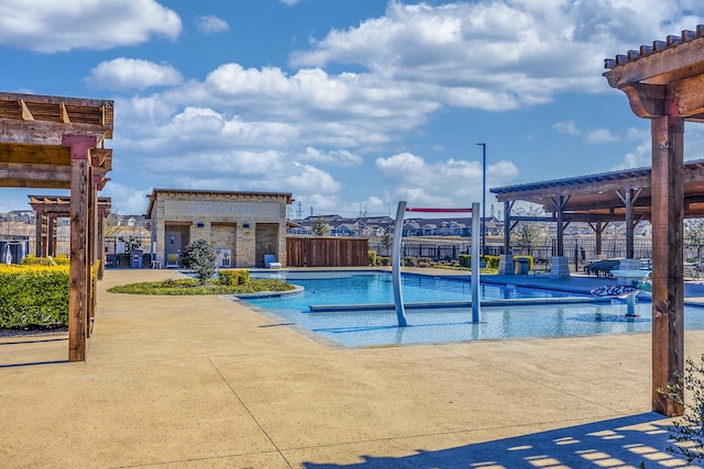 view of pool with a pergola and fence