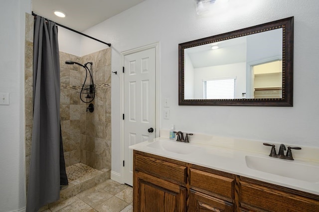 bathroom featuring walk in shower, vanity, and tile patterned flooring