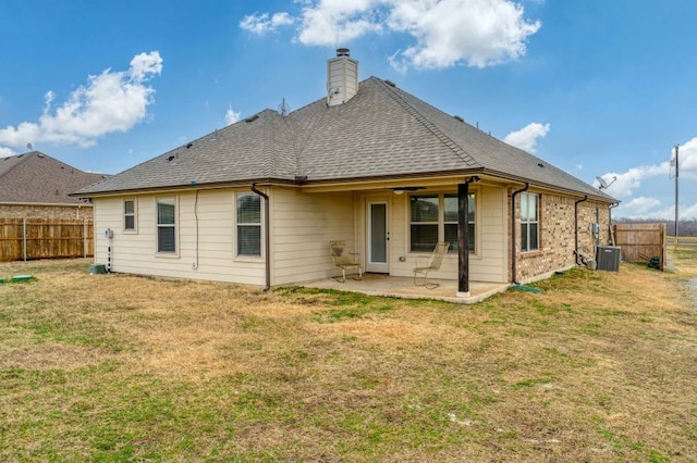 rear view of house featuring a patio area and a lawn