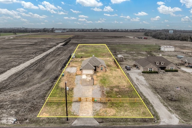 birds eye view of property with a rural view