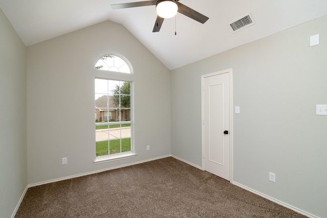 empty room with vaulted ceiling, carpet flooring, and ceiling fan