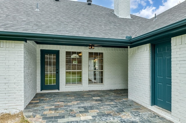 view of exterior entry featuring a patio and ceiling fan