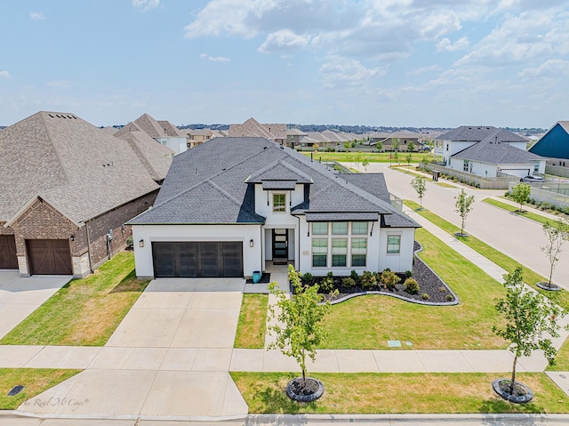 view of front of house featuring a garage and a front yard