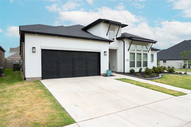 view of front of house featuring a garage, central AC, and a front yard