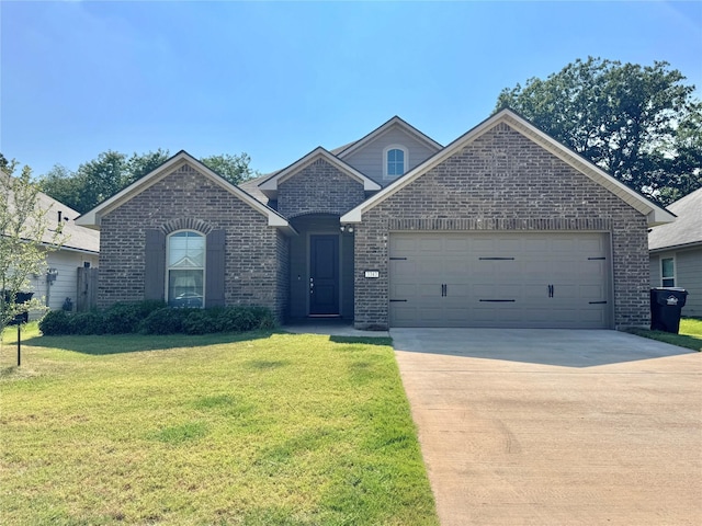 view of front of house with a garage and a front lawn