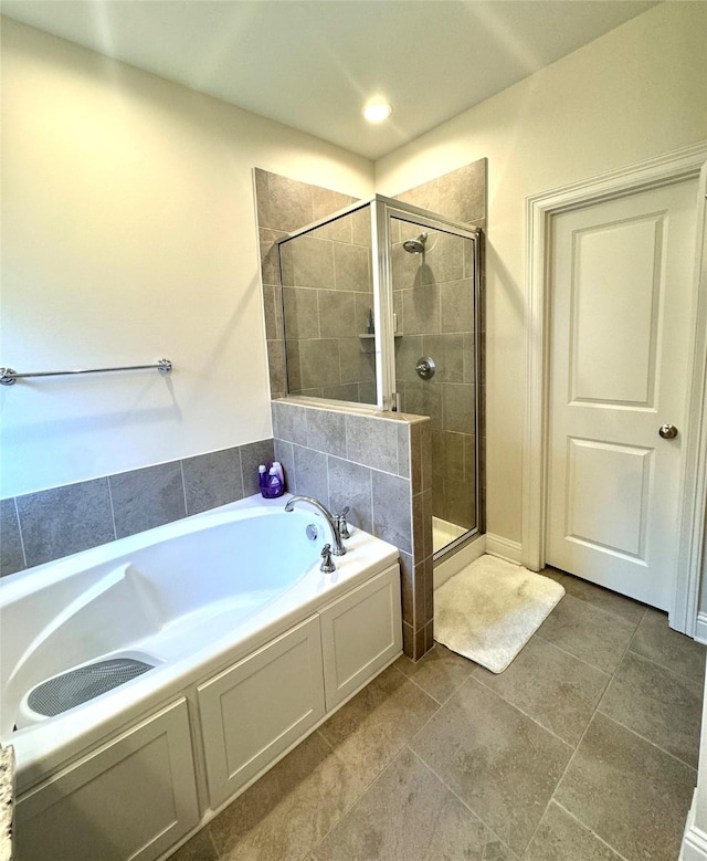 bathroom with shower with separate bathtub