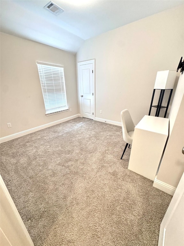 office with vaulted ceiling and carpet