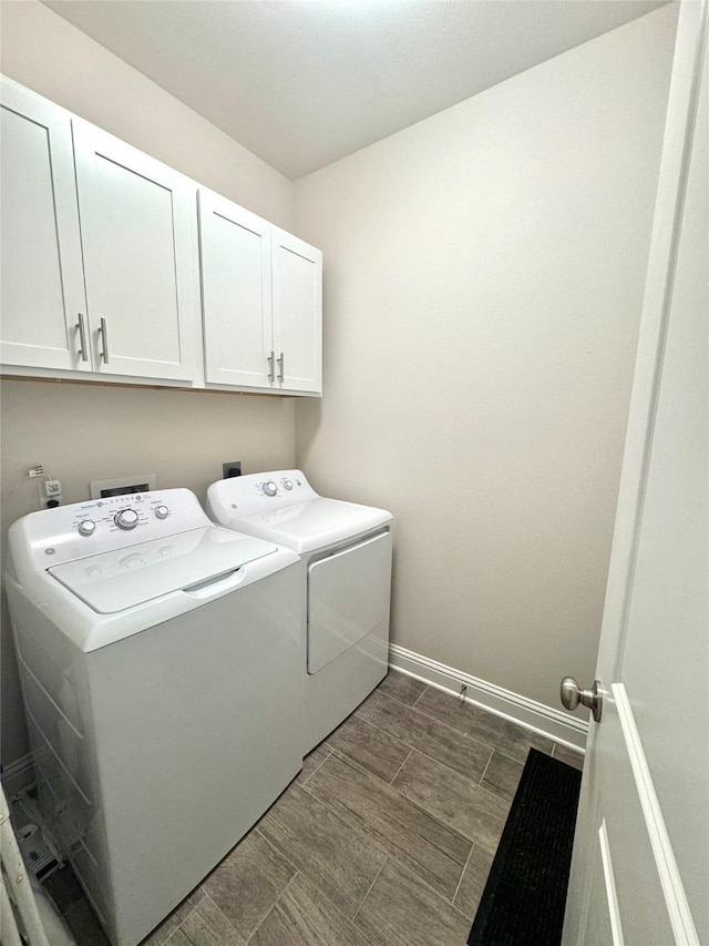 laundry room featuring cabinets and washing machine and clothes dryer