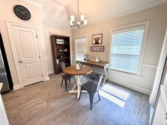 dining room featuring hardwood / wood-style flooring, crown molding, vaulted ceiling, and a chandelier