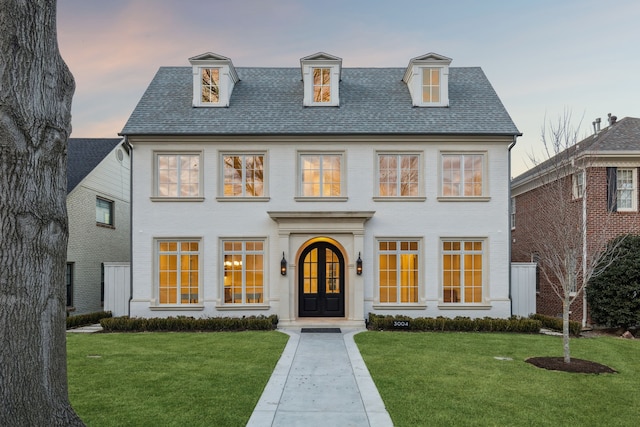 view of front of house featuring a lawn and french doors