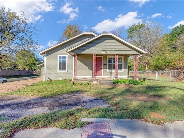 bungalow-style home with covered porch and a front yard