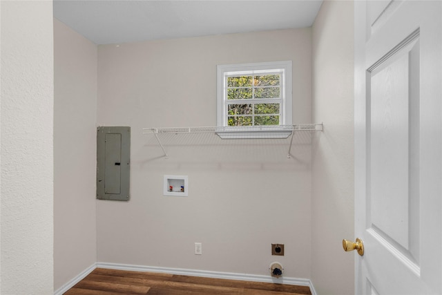 laundry room featuring dark hardwood / wood-style flooring, hookup for a washing machine, electric panel, and hookup for an electric dryer