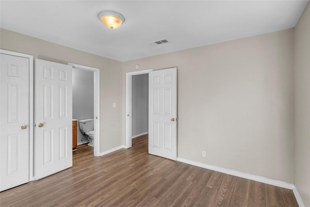 unfurnished bedroom featuring dark hardwood / wood-style floors