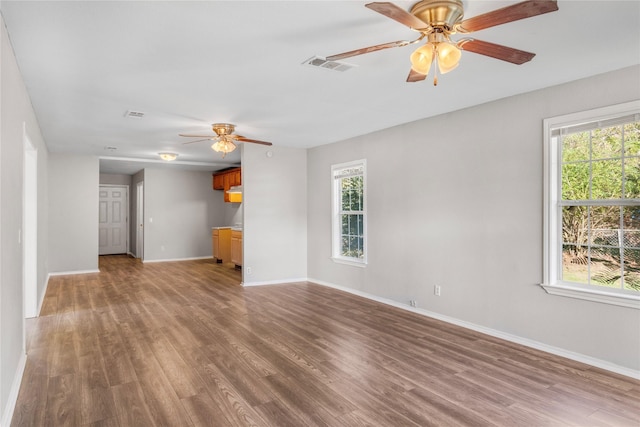 unfurnished living room with wood-type flooring and a healthy amount of sunlight