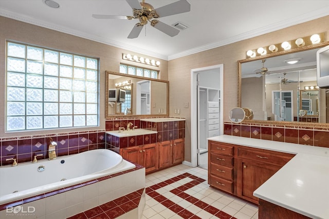 bathroom with tiled bath, tile patterned flooring, vanity, ceiling fan, and crown molding