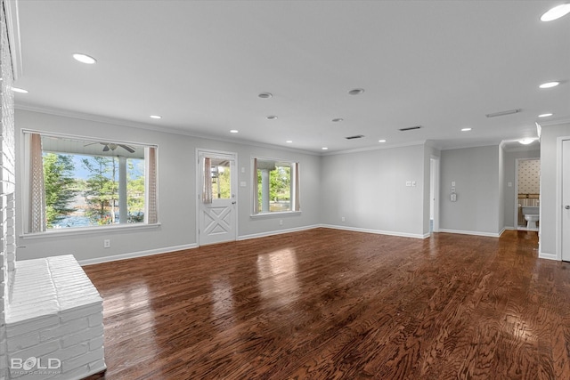 unfurnished living room featuring crown molding and dark wood-type flooring