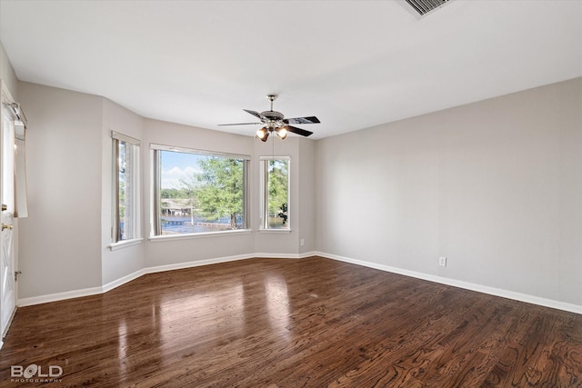 spare room featuring ceiling fan and dark hardwood / wood-style flooring