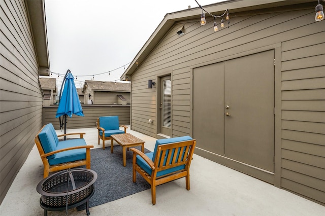 view of patio / terrace featuring an outdoor living space with a fire pit