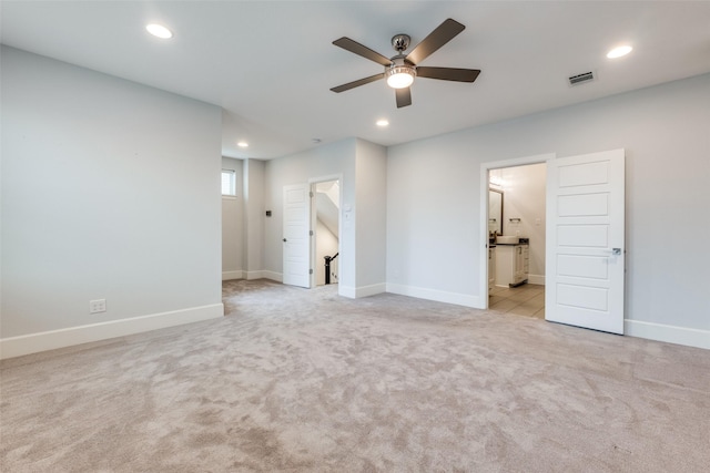 empty room featuring light colored carpet and ceiling fan