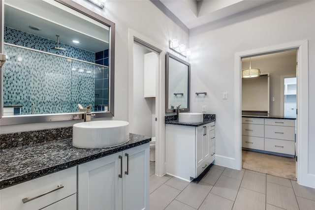 bathroom featuring vanity, toilet, and an enclosed shower