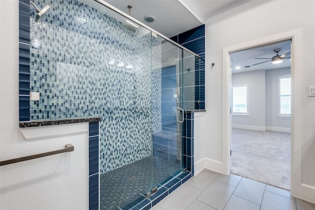 bathroom with tile patterned flooring, an enclosed shower, and ceiling fan