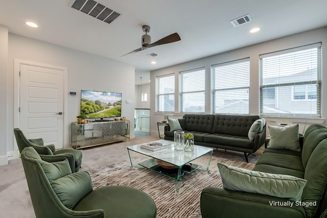 living room featuring ceiling fan and light colored carpet