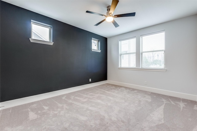 carpeted empty room featuring ceiling fan