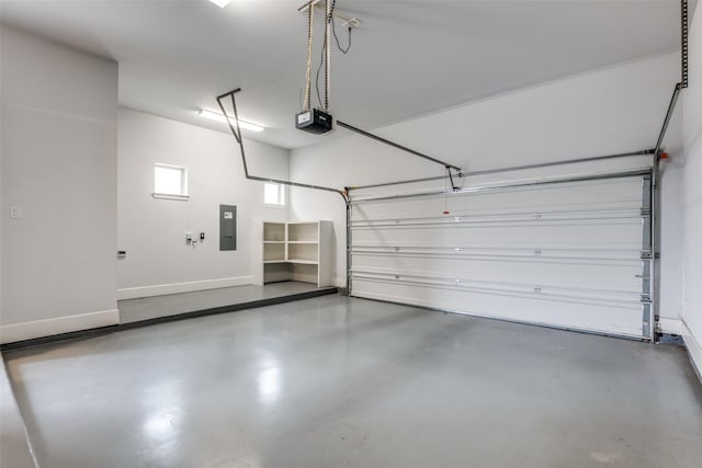 garage with a garage door opener and electric panel