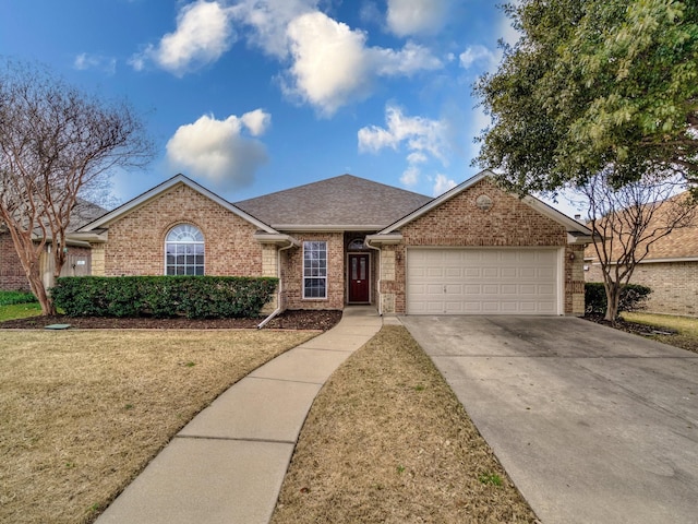 ranch-style home with a garage and a front lawn