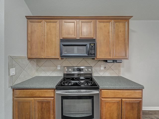 821 Grace Ln, Saginaw, TX 76179 - kitchen with black microwave, electric range, backsplash, and dark countertops