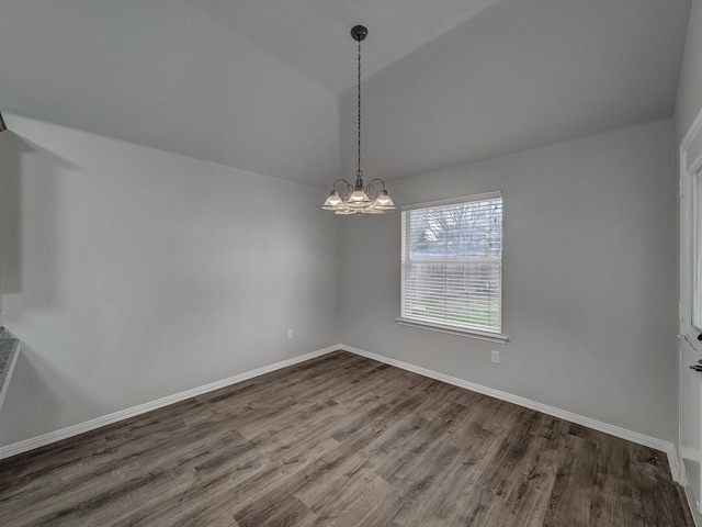 unfurnished room with hardwood / wood-style floors, vaulted ceiling, and a chandelier