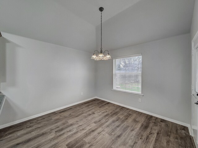 821 Grace Ln, Saginaw, TX 76179 - unfurnished dining area with dark wood-type flooring, a chandelier, vaulted ceiling, and baseboards