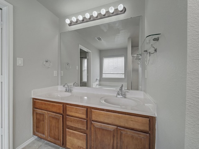 bathroom featuring vanity and a bath