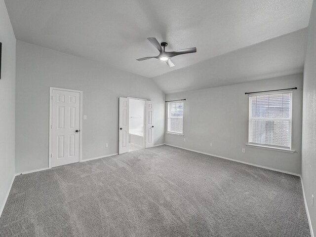 821 Grace Ln, Saginaw, TX 76179 - unfurnished bedroom featuring lofted ceiling, carpet floors, baseboards, ensuite bath, and a ceiling fan